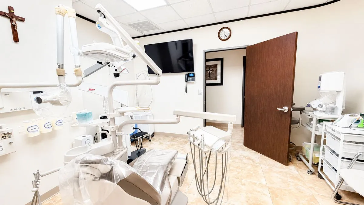 Treatment room with Leica F12 microscope and mahogany finishes