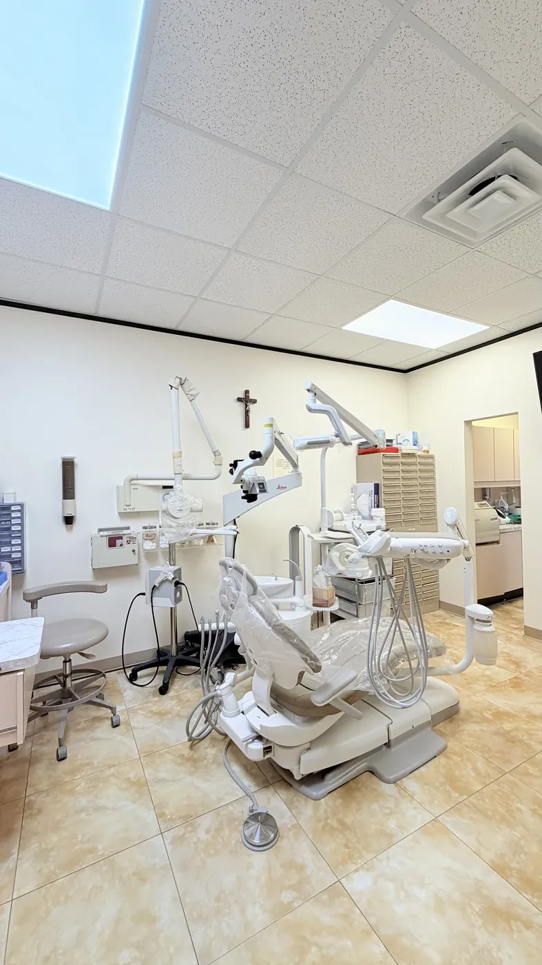 A wide view of a SoftDental operatory with the Leica microscope arm, dental chair, and sterile field